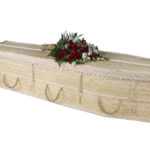 The Bamboo Woven Coffin with red rose, white flower and greenery spray on top