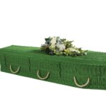 The Cane Coffin in green with white flower spray