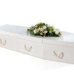 The Cardboard Coffin in white with mixed white flower spray on top