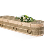 The Pandanus Coffin with mixed white flower bouquet on top