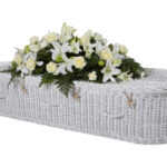 The Somerset Willow Colours Coffin in white with white flower spray on top
